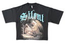 A black short-sleeve graphic t-shirt featuring the band name 'Silent Verse' in a stylized light blue font above a detailed illustration of an angel comforting a seated figure, shown against a plain white background. By Fresh N Fitted.