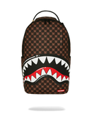 A Spraycraft Shark backpack in brown and black monogram canvas with a large shark mouth graphic in white, red, and black on the front, shown against a plain white background. By Fresh N Fitted