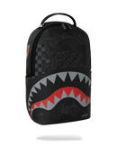 A black Spraycraft Shark backpack with a graphic of a shark mouth in red, gray, and white, featuring a subtle dark patterned background and a top carry handle. By Fresh N Fitted