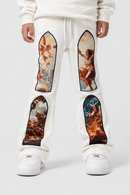 A person wearing Cream sweatpants with large classical painting panels printed on the thighs, paired with white sneakers, shown against a light gray studio background.