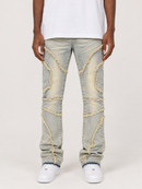 A person wearing light-wash distressed denim jeans with decorative frayed trim details, paired with a white t-shirt and white sneakers, shown from the waist down on a light gray studio background.