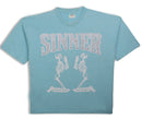 Light blue t-shirt with 'Sinner' text and skeleton graphics on a white background