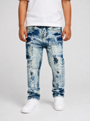 A child wearing light blue heavily distressed and faded denim jeans with ripped details, styled with a white t-shirt and white sneakers against a light gray studio background.