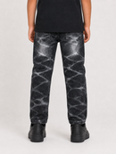 A person shown from the back wearing black jeans with a white marble-like distressed pattern, a black t-shirt, and black shoes, against a light gray studio background.