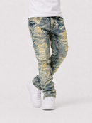 A person wearing distressed acid-wash blue jeans with yellowing and fading, styled with a white t-shirt and white sneakers against a light gray studio background.