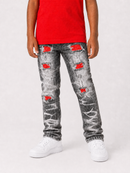 A person wearing distressed gray jeans with red patchwork details, a red top, and white sneakers, shown from the waist down against a light gray studio background.