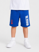 A child wearing royal blue shorts with a white distressed vertical 'KINGS' graphic on the right leg and a red distressed 'K' with a heart on the left leg, styled with a white t-shirt, white socks, and white sneakers against a light gray background.