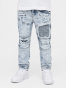 Light blue acid-wash distressed jeans with ripped details and a striped patch on the right thigh, shown on a model wearing a white t-shirt and white sneakers against a white background.