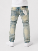 Rear view of a person wearing light blue washed denim jeans with white sneakers against a clean white studio background.