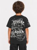A child viewed from behind wearing a black graphic T-shirt with large white gothic text and smoky gray artwork on the back, paired with black cargo pants, against a light gray studio background.