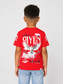 A child model shown from the back wearing a bright red Givenchy t-shirt with a large white and gray eagle graphic and text on the back, paired with light blue jeans, against a light gray studio background.