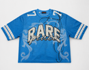 A blue short-sleeve t-shirt with 'RARE grace' written across the front in white and black script, embellished with rhinestones. The shirt features white scrollwork designs on the front and sleeve cuffs with white stripes and rhinestone borders. By Fresh N Fitted