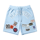 Light blue shorts with various patches on a white background. by Fresh n Fitted