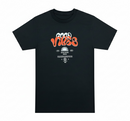 A black short-sleeve crewneck t-shirt with a retro-style graphic on the chest reading 'GOOD VIBES' in orange and white, with smaller text below, shown on a plain white background. By Fresh N Fitted.