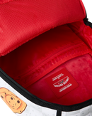 Close-up of the interior of a red backpack, showing a red interior lining with a visible 'SPYDERGROUND LIMITED EDITION' patch and a zipper track.