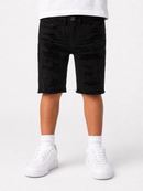 Black distressed denim shorts with raw frayed hems, shown on a model from the waist down wearing white sneakers and white socks against a light gray background.