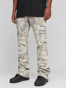 A person wearing light gray and beige camouflage cargo pants with black shoes, shown from the waist down against a light gray studio background.