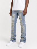 Light blue distressed denim jeans with ripped details showing tan lining, worn by a model with a white t-shirt and white sneakers against a white studio background.
