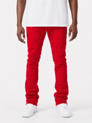 A person wearing bright red distressed skinny jeans with ripped details on the thighs and knees, styled with a white t-shirt and white sneakers against a plain white studio background.