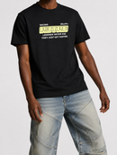 A man wearing a black short-sleeve t-shirt with a yellow and white 'Retro Racing' graphic on the chest, paired with light-wash denim jeans, against a light gray studio background. fresh n fitted best clothing store for men in Stockton California
