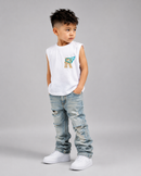 A young boy modeling a sleeveless white crop top with a colorful graphic on the chest, paired with light-wash distressed jeans and white sneakers, against a solid gray studio background.