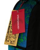 Close-up of a sprayground backpack with a red Sprayground hangtag and a yellow graphic hangtag attached, showing a blue and green patterned fabric and black side panel.