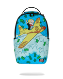 A Sprayground backpack featuring a colorful cartoon graphic of a blonde character flying a yellow airplane through white clouds with green dollar bills, shown on a plain white background.