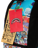 Close-up of a sprayground backpack featuring a vibrant multicolor cartoon character print, black mesh side panels, and a bright red hangtag with a shark mouth graphic.