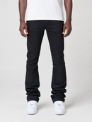A model from the waist down wearing black slim-fit jeans, a white t-shirt, and white sneakers, standing against a light gray studio background.