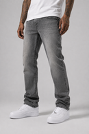 A person wearing slim-fit gray denim jeans with a faded wash, paired with a white t-shirt and white sneakers, shown from the waist down against a light gray studio background.