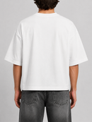 White Silent Verse Grace oversized cropped T-shirt with pink accents, casual style, and relaxed fit, displayed on a hanger.